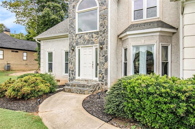 entrance to property featuring central AC unit