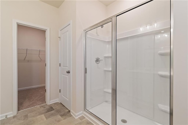 bathroom featuring a shower with door