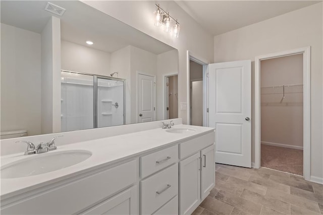 bathroom featuring vanity, toilet, and an enclosed shower