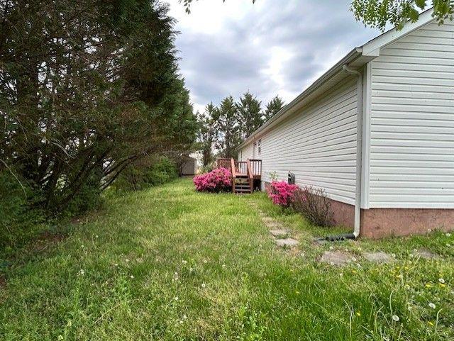 176 Elbert St, Chatsworth, GA 30705 - view of green lawn featuring a deck