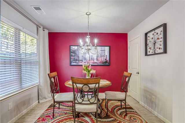 dining area with a notable chandelier and light colored carpet