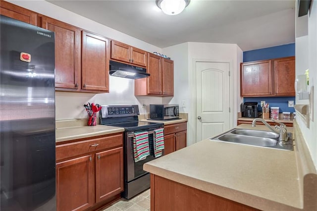 kitchen with a sink, stainless steel appliances, light countertops, under cabinet range hood, and brown cabinets