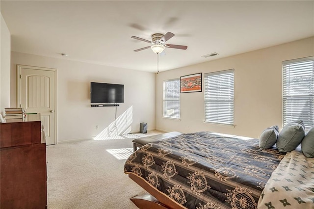 bedroom featuring visible vents, carpet floors, baseboards, and a ceiling fan