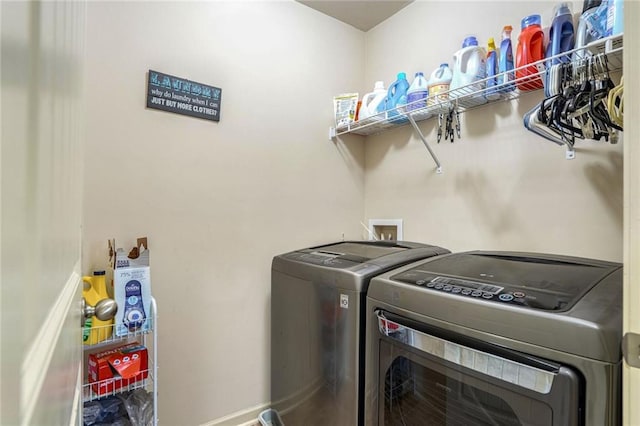 washroom featuring laundry area, independent washer and dryer, and baseboards