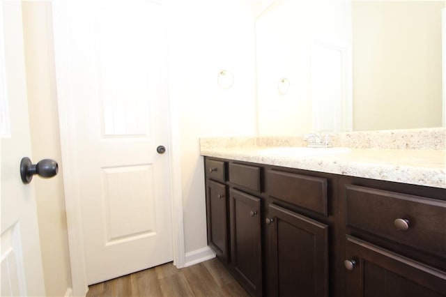 bathroom with hardwood / wood-style floors and vanity