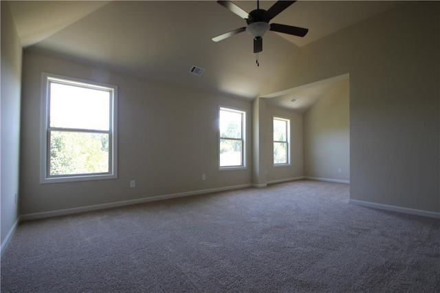 unfurnished room featuring carpet floors, vaulted ceiling, and ceiling fan