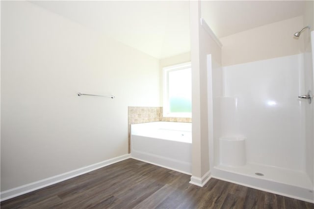 bathroom with plus walk in shower and wood-type flooring