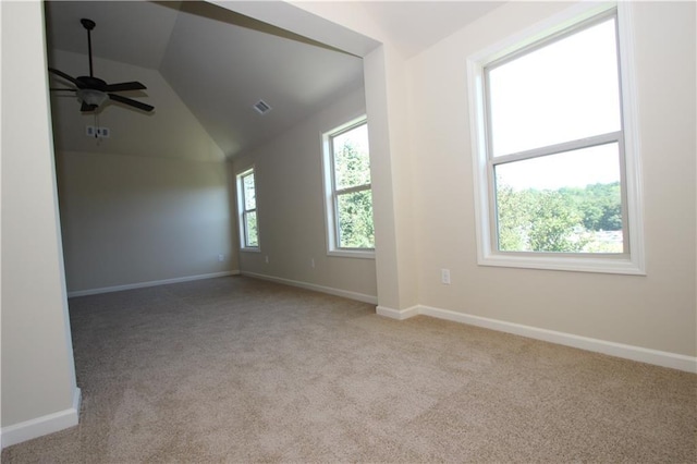 carpeted spare room featuring ceiling fan and lofted ceiling