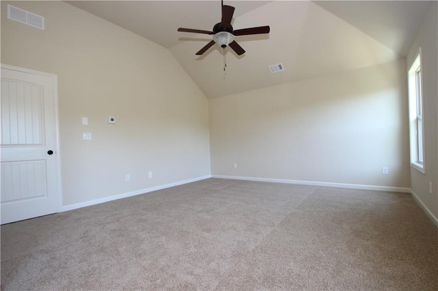 carpeted spare room with ceiling fan and lofted ceiling