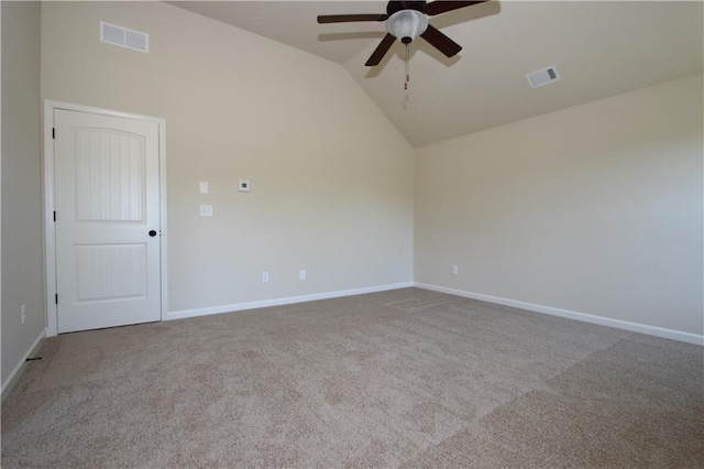 unfurnished room with light colored carpet, vaulted ceiling, and ceiling fan