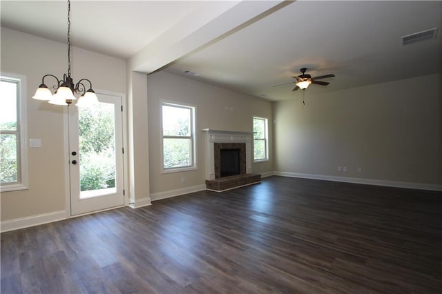 unfurnished living room featuring beam ceiling, dark hardwood / wood-style flooring, and ceiling fan with notable chandelier