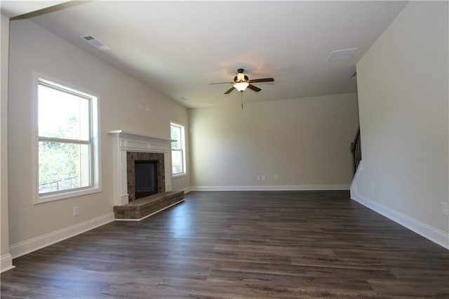 unfurnished living room with ceiling fan and dark wood-type flooring