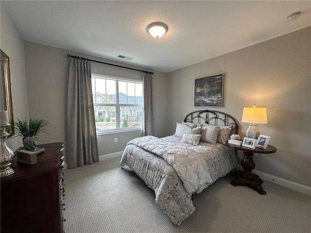 carpeted bedroom with baseboards and visible vents
