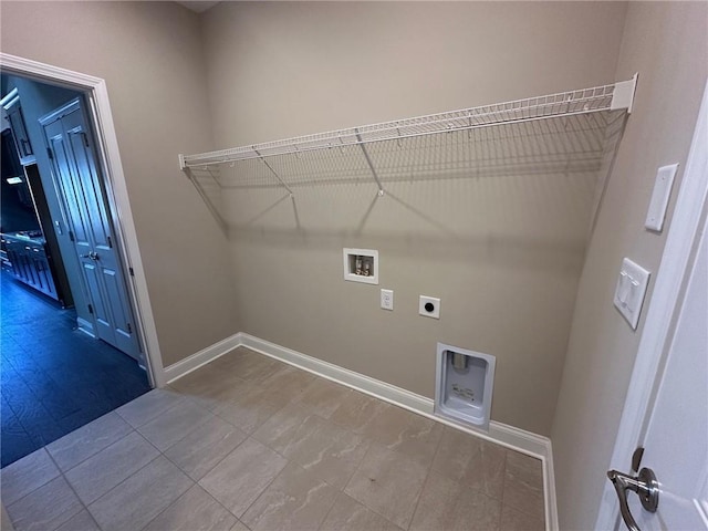 clothes washing area featuring electric dryer hookup, hookup for a washing machine, baseboards, and laundry area