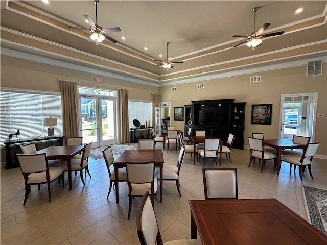 dining room with a raised ceiling, ceiling fan, light tile patterned flooring, and visible vents