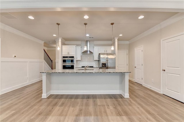 1431 Winding Ridge Trl, Buford, GA 30548 - kitchen featuring appliances with stainless steel finishes, ornamental molding, wall chimney range hood, white cabinets, and decorative backsplash