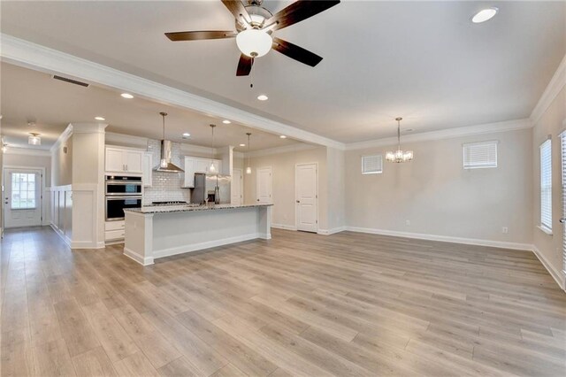 1431 Winding Ridge Trl, Buford, GA 30548 - unfurnished living room featuring light wood-style flooring, crown molding, a chandelier, ceiling fan, and recessed lighting
