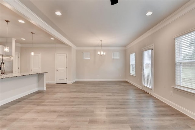 1431 Winding Ridge Trl, Buford, GA 30548 - unfurnished living room featuring ornamental molding, light wood-type flooring, a chandelier, and recessed lighting