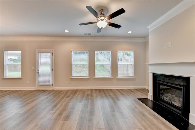 1431 Winding Ridge Trl, Buford, GA 30548 - unfurnished living room featuring a fireplace, ornamental molding, light wood-style floors, ceiling fan, and healthy amount of natural light