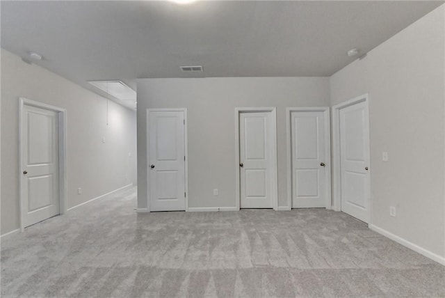 1431 Winding Ridge Trl, Buford, GA 30548 - unfurnished bedroom with attic access, light carpet, and two closets