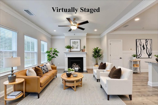 1431 Winding Ridge Trl, Buford, GA 30548 - living room featuring light wood-type flooring, a ceiling fan, a fireplace with flush hearth, recessed lighting, and ornamental molding