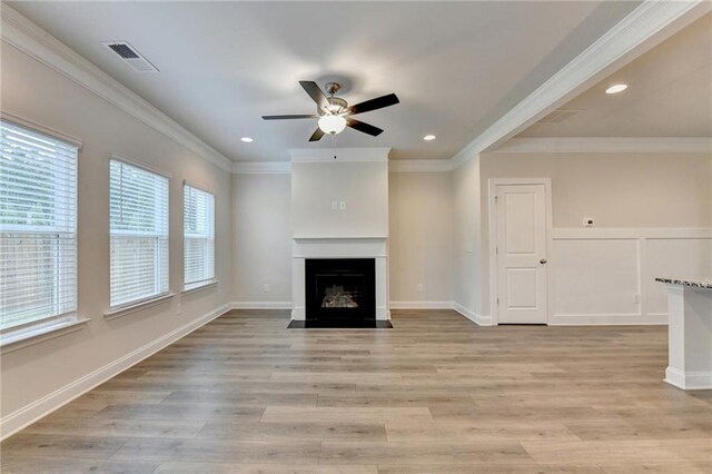 1431 Winding Ridge Trl, Buford, GA 30548 - unfurnished living room featuring a fireplace with flush hearth, a ceiling fan, light wood-style floors, recessed lighting, and crown molding