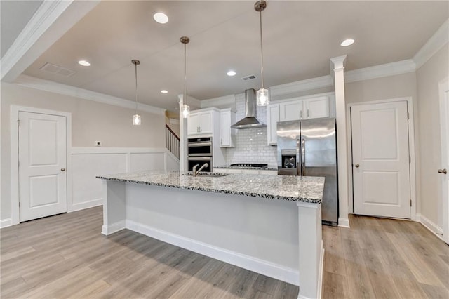 1431 Winding Ridge Trl, Buford, GA 30548 - kitchen with stainless steel appliances, wall chimney range hood, ornamental molding, white cabinetry, and tasteful backsplash