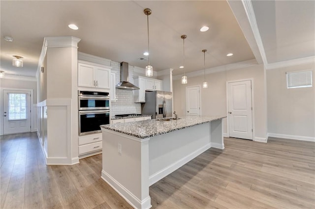 1431 Winding Ridge Trl, Buford, GA 30548 - kitchen with appliances with stainless steel finishes, wall chimney range hood, light wood-style flooring, crown molding, and white cabinets