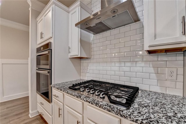 1431 Winding Ridge Trl, Buford, GA 30548 - kitchen featuring ventilation hood, stainless steel appliances, ornamental molding, white cabinetry, and light stone countertops
