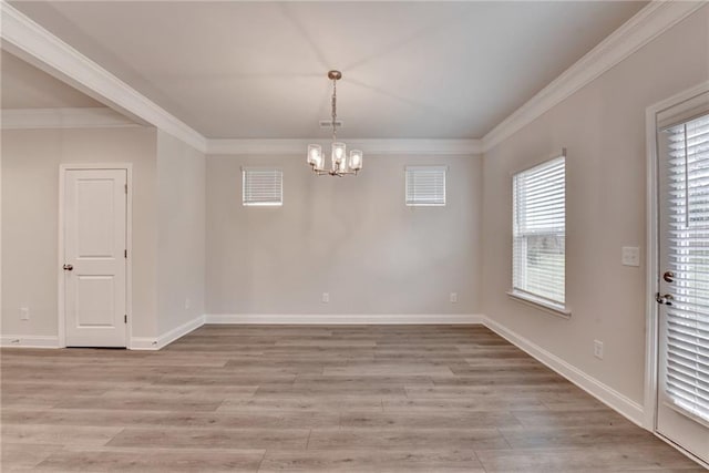 1431 Winding Ridge Trl, Buford, GA 30548 - unfurnished dining area featuring crown molding, a chandelier, and light wood-style flooring