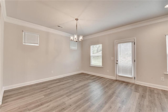1431 Winding Ridge Trl, Buford, GA 30548 - empty room featuring crown molding, a chandelier, and light wood-type flooring