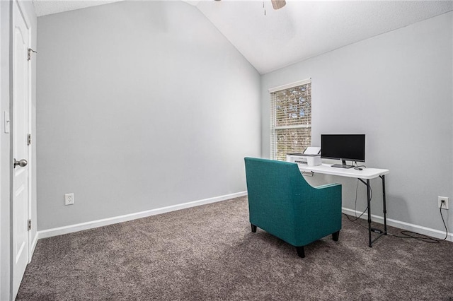 office space with a ceiling fan, lofted ceiling, dark carpet, and baseboards