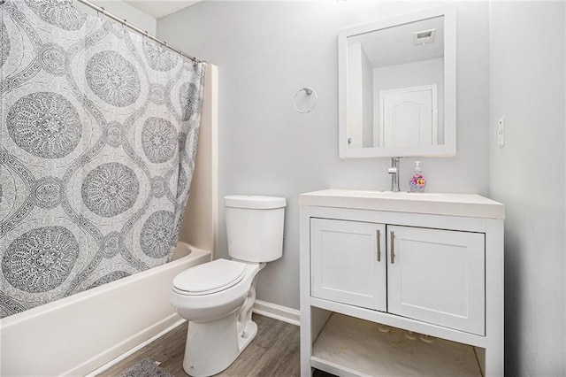 full bathroom with visible vents, toilet, wood finished floors, shower / bath combination with curtain, and vanity