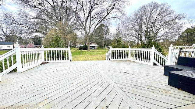 wooden terrace featuring a yard