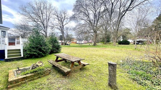 view of green lawn with a deck