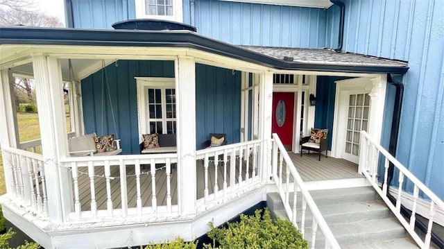 doorway to property with board and batten siding and a porch