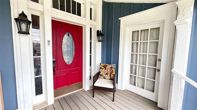 property entrance featuring board and batten siding and a porch