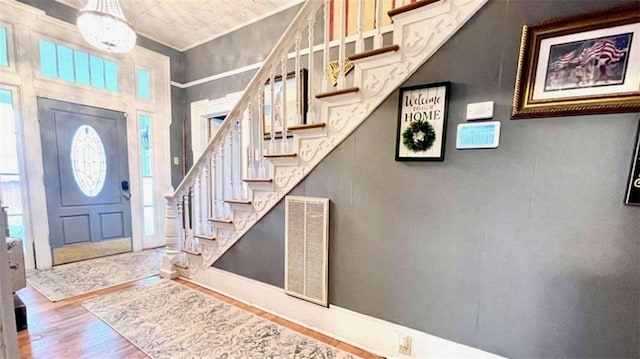 foyer featuring wood finished floors and stairs