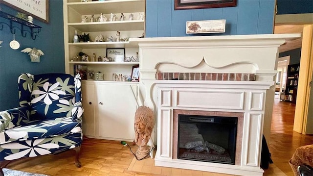 detailed view of wood finished floors and a fireplace