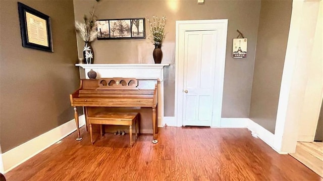 living area with wood finished floors and baseboards