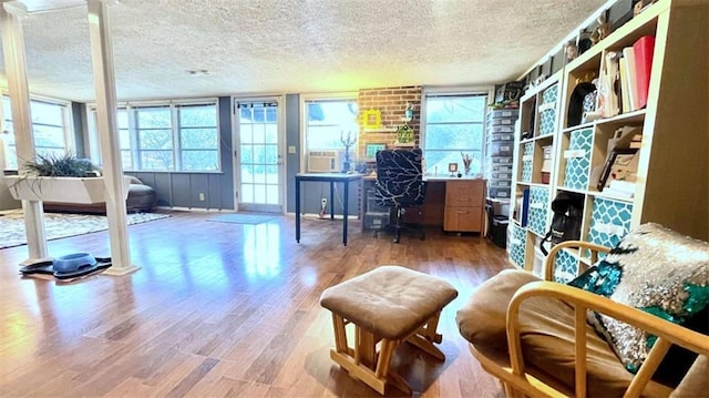 office with a textured ceiling and wood finished floors