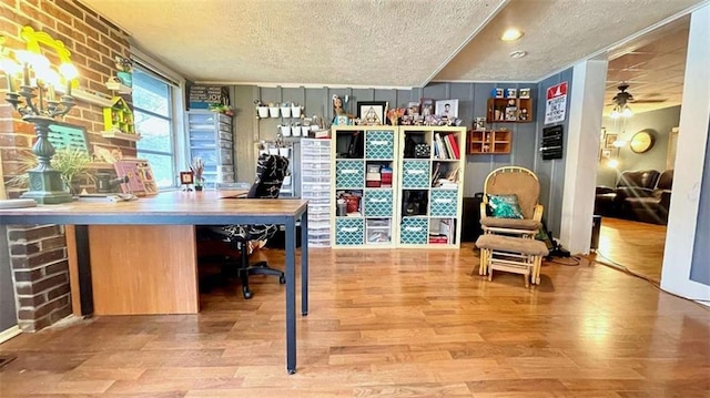 office space featuring a textured ceiling, wood finished floors, and a ceiling fan