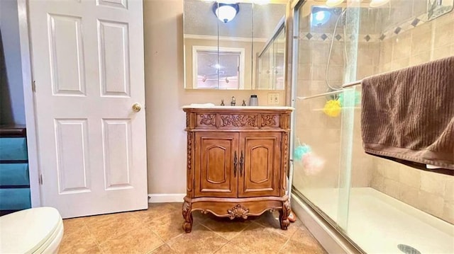 full bathroom with a shower stall, vanity, tile patterned floors, and toilet