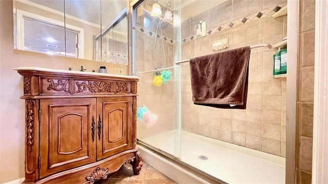 bathroom with ornamental molding, a stall shower, tile patterned floors, and vanity