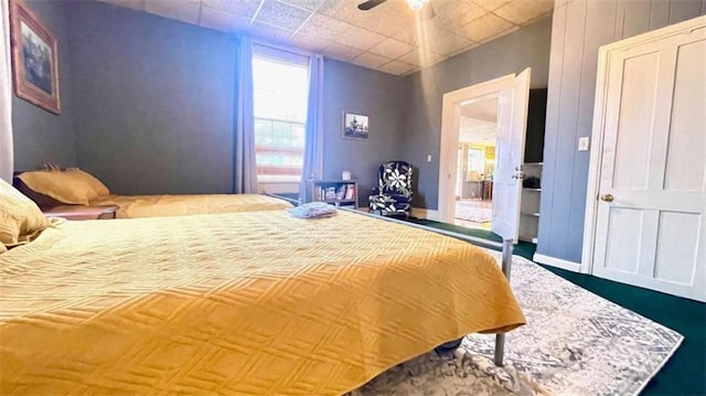 bedroom with baseboards and ceiling fan