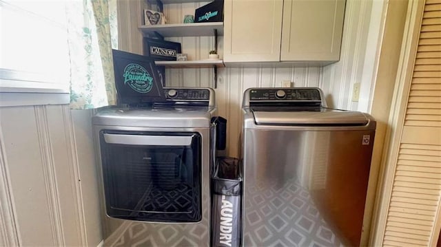 clothes washing area with cabinet space and washer and dryer