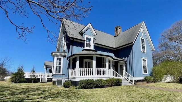 rear view of property with central AC, a lawn, a chimney, a deck, and roof with shingles