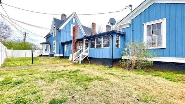 rear view of house featuring board and batten siding and central air condition unit