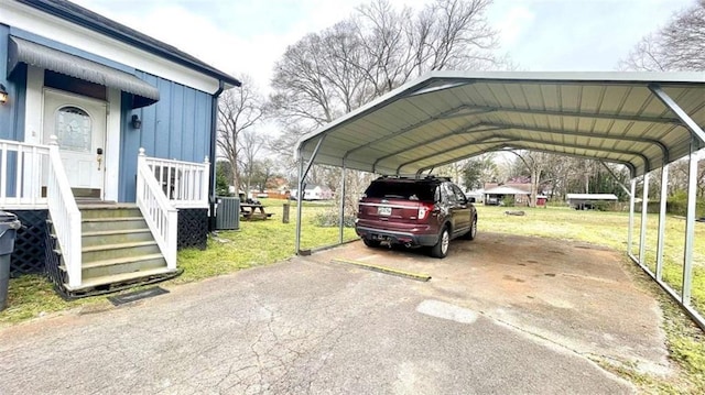 view of parking / parking lot featuring a carport and driveway