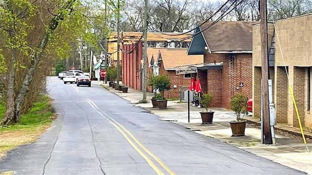 view of asphalt road with traffic signs